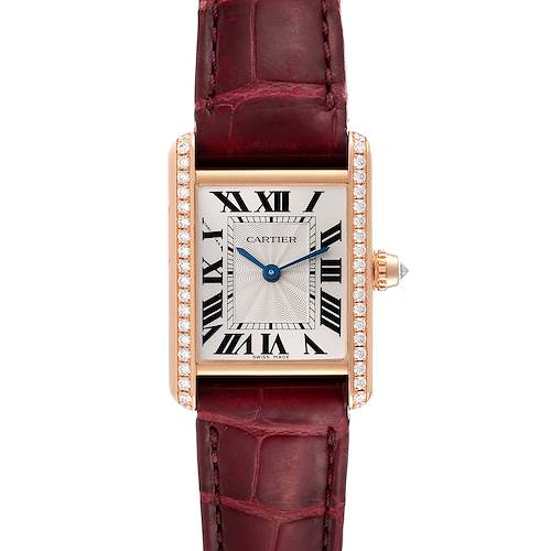 The image shows a frontal view of the Cartier Tank Louis watch, highlighting its face, Roman numerals, diamond-set case, and burgundy strap.